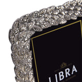 Close-up of the Libra Interiors Antiqued Leaf aluminium photo frame in silver, showing the raised leaf motif border in antiqued pewter finish.
