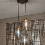 Libra Interiors Hammered Glass 3 Light Drop Chandelier in brown with tulip-shaped lustred glass shades at staggered heights from a champagne gold ceiling rose.