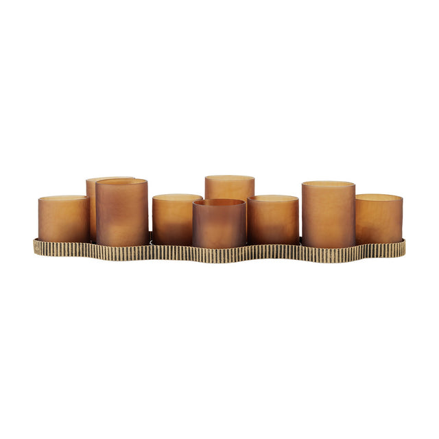 Libra Interiors Hammered Glass 9-Light Amber Lantern with nine matt amber votive cups at alternating heights on a corrugated aged gold iron base.