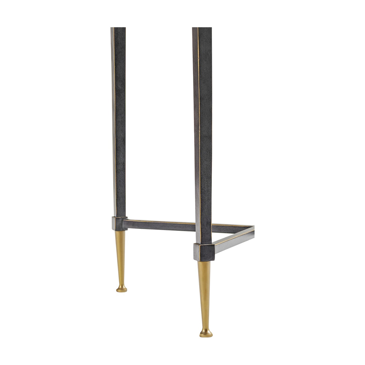 Close-up of the lower iron frame and tapered brass-look feet on the Libra Interiors Textured Glass Top Iron Side Table in black.