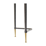 Close-up of the lower iron frame and tapered brass-look feet on the Libra Interiors Textured Glass Top Iron Side Table in black.