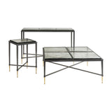 Libra Interiors Textured Glass Square Coffee Table in black with matching side table and console, iron frames with brass-toned tapered feet, on white.