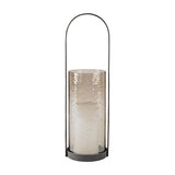 Libra Interiors Hammered Glass Arched Handle Hurricane Lantern in brown with textured glass cylinder, pillar candle and tall twisted iron handle.