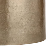 Close-up of the Libra Interiors Drum Storage Coffee Table showing its pitted champagne gold aluminium surface with soft sheen and textured patina finish.