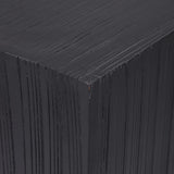Close-up of Libra Interiors Grooved Wood Black Display Plinth showing the matt black mango wood corner with vertical carved linear grooves.