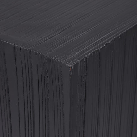 Close-up of Libra Interiors Grooved Wood Black Display Plinth showing the matt black mango wood corner with vertical carved linear grooves.