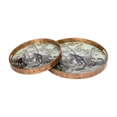 Libra Interiors Round Glass Monkey Jungle Serving Tray set of two in cream and antiqued gold, printed with a botanical monkey scene, on a white background.