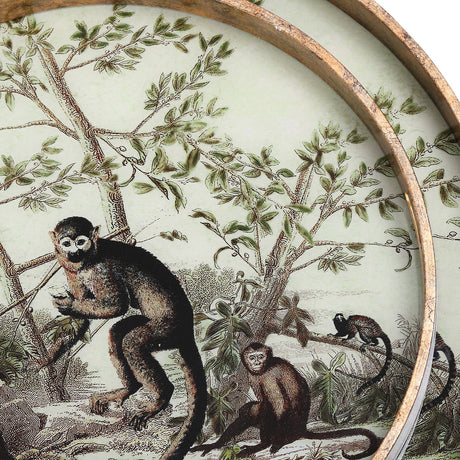 Close-up of Libra Interiors Round Glass Monkey Jungle serving tray in gold, showing the printed monkeys among leafy branches behind glass with antiqued frame.