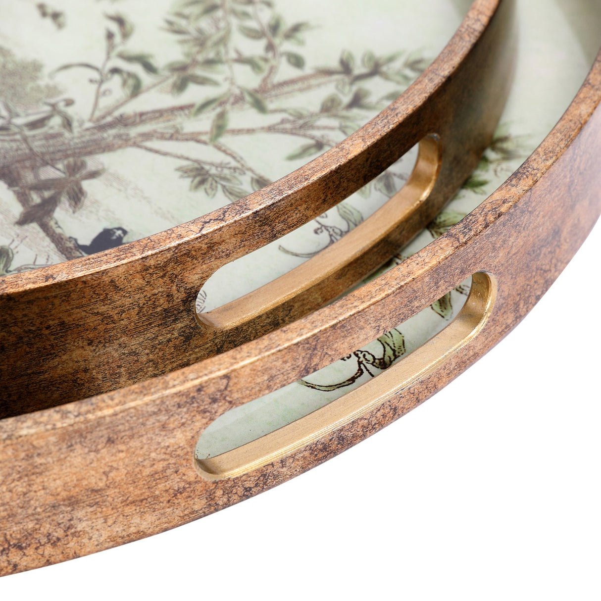 Close-up of Libra Interiors Round Glass Monkey Jungle serving trays, nested pair with antiqued gold frames, inset handles, and cream botanical print.