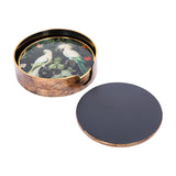 Libra Interiors Tropical Bird round acrylic coaster set in antique gold holder, showing white cockatoo print design and a plain black coaster beside it.
