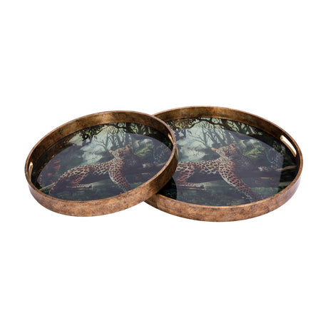 Libra Interiors Leopard Glass Round Serving Tray set of two in gold, with lounging leopard jungle print beneath glass and antiqued gold-effect rims.