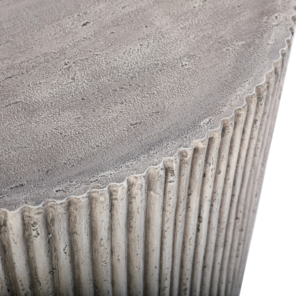 Close-up of Libra Interiors Fluted Round Coffee Table in grey, showing the textured stone effect top edge meeting the vertical ribbed cylindrical side.