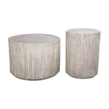 Libra Interiors Fluted Round Coffee Table in grey shown with a taller matching side table, both cylindrical with ribbed stone effect finish, on white.
