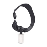 Libra Interiors Looping Abstract sculpture with a matt black cast aluminium open-ring form on a cylindrical white marble base, on a plain background.