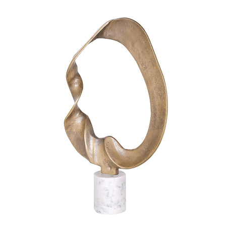 Libra Interiors Abstract Aluminium Ring Sculpture in antique gold, twisted looping form on a cylindrical white marble base, shown against a plain background.