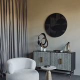 Libra Interiors Abstract Aluminium Ring Sculpture in gold paired with a black version on a patterned sideboard, styled in a neutral living room setting.
