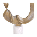Close-up of Libra Interiors Abstract Aluminium Ring Sculpture in gold, showing the twisted antique gold looping form meeting the white marble cylindrical base.