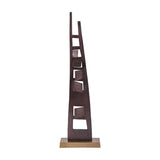 Libra Interiors tall aluminium sculpture in blackened bronze with tapered asymmetric uprights, geometric cut-outs and angular blocks on a brass-toned base.