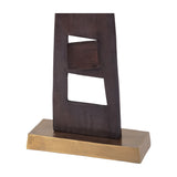 Libra Interiors tall geometric cut-out aluminium sculpture in blackened bronze, showing the lower section with angular openings on a brass-toned base.