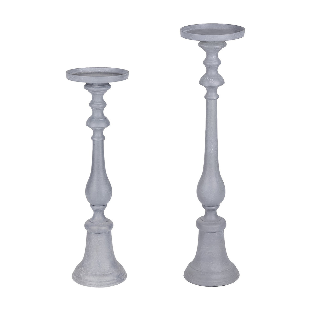 Libra Interiors stonewashed aluminium pillar candle holders in grey, shown as a tall and shorter turned candlestick pair with plate tops on a white background.