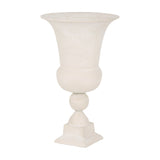Libra Interiors Stonewash Aluminium Urn Vase in cream with flared rim, rounded bowl, spherical stem detail and stepped square plinth on a white background.
