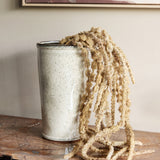 Libra Interiors Speckled Glazed Tall Ceramic Planter in white holding dried trailing amaranthus on a wooden console beneath a framed artwork.