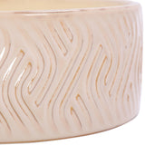 Close-up of Libra Interiors Embossed Glazed Ceramic Bowl Candle in ivory, showing the glossy glaze and raised flowing geometric line pattern on the outer wall.
