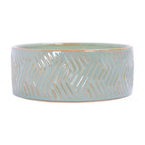 Libra Interiors Embossed Ceramic Bowl Triple-Wick Candle in soft blue-green with a wavy embossed pattern and amber clay showing through, on a white background.