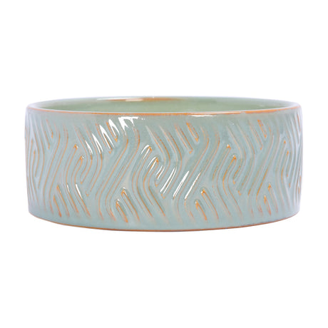 Libra Interiors Embossed Ceramic Bowl Triple-Wick Candle in soft blue-green with a wavy embossed pattern and amber clay showing through, on a white background.