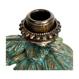 Close-up of the Libra Interiors Palm and Elephant resin candle holder in gold, showing the taper candle fitting atop the palm trunk with green-toned fronds.