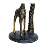 Close-up of the Libra Interiors Giraffe and Palm Resin Candle Holder base, showing slender giraffe legs and textured palm trunk in aged gold.