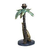 Libra Interiors Palm Tree and Leopard Candle Holder in gold resin with verdigris fronds and seated leopard at the trunk, on a plain white background.