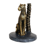 Libra Interiors Palm Tree and Leopard Candle Holder in gold resin, close-up of the seated spotted leopard beside the textured palm trunk on an oval base.