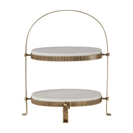 Libra Interiors Marble Two Tier Cake Stand in white with oval Banswara marble platters, corrugated aged gold iron frame and arched handle.