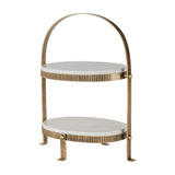 Libra Interiors Marble Two Tier Cake Stand in white with oval Banswara marble tiers, ribbed antique gold iron frame and arched handle.