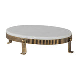 Libra Interiors Marble Oval Aged Gold Cake Stand in white, with a white marble top on a corrugated aged gold iron base with four splayed feet.
