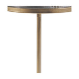 Close-up of the Libra Interiors Two-Tier Marble Side Table showing a dark marble top edge set in a burnished gold iron ring above a slim tubular stem.