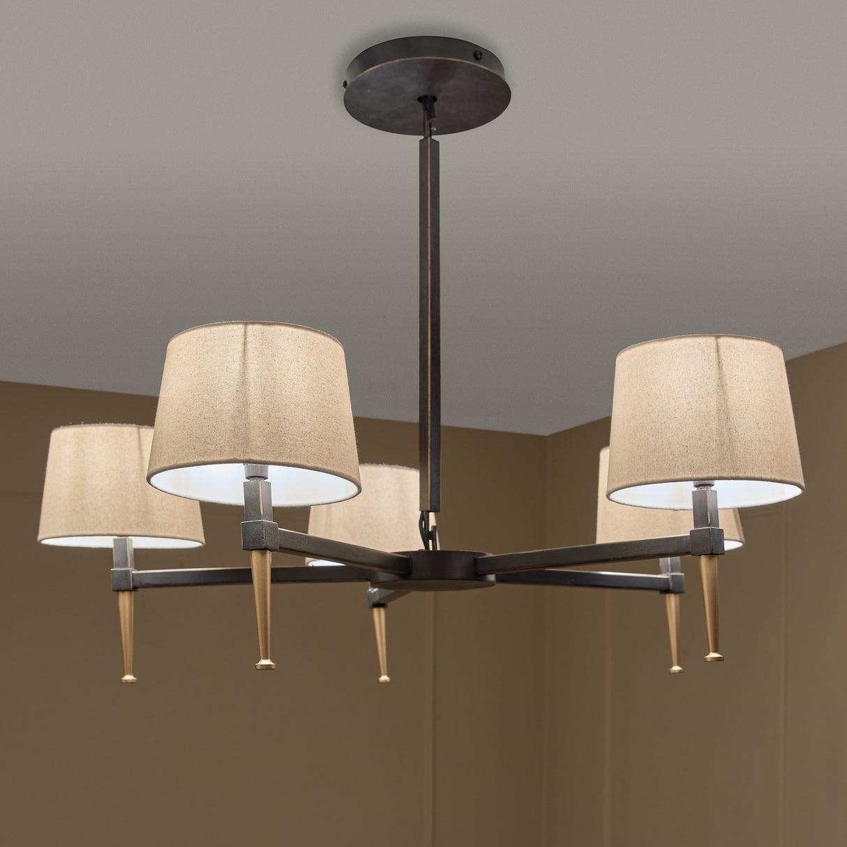 Libra Interiors Bronze Iron 5 Light Linen Chandelier with bronze frame, gilded accents and five linen shades, shown installed against a neutral ceiling.