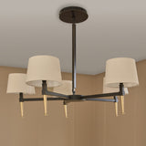 Libra Interiors Bronze Iron 5 Light Linen Chandelier with cream linen shades, bronze frame and gold tapered accents, mounted to a neutral ceiling.