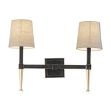 Libra Interiors Twin Linen Shade Bronze Wall Light with two tapered arms, dark iron frame, gold accents and bleached linen shades on a white background.