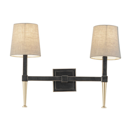 Libra Interiors Twin Linen Shade Bronze Wall Light with two tapered arms, dark iron frame, gold accents and bleached linen shades on a white background.