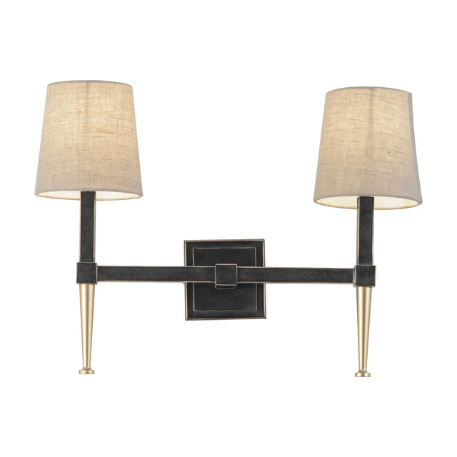 Libra Interiors Twin Linen Shade Bronze Wall Light with two tapered arms, dark iron frame, gold accents and bleached linen shades on a white background.