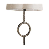 Libra Interiors Hammered Iron floor lamp detail showing the bronze stem with circular open ring motif beneath a scalloped natural linen shade.