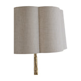 Libra Interiors Hammered Oval Gold Floor Lamp shown in close-up, with a scalloped ivory woven linen shade sitting atop a hammered champagne gold iron stem.