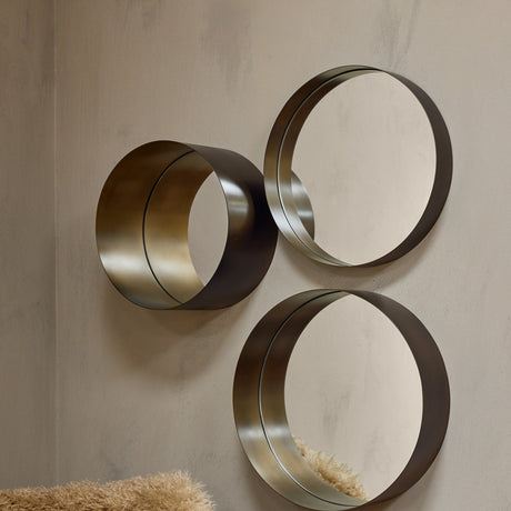Libra Interiors Set of 3 Nested Round Wall Mirrors in gold, arranged in a cluster on a neutral wall showing graduating sizes with deep metal frames.