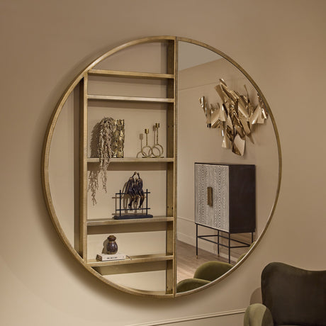 Libra Interiors Round Gold Shelving Wall Mirror with champagne gold iron frame, five open display shelves and mirrored half, styled in a neutral living space.
