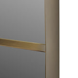 Close-up of the Libra Interiors Smoked Gold Iron Ledge Wall Mirror showing the slim integrated brass-toned ledge and rounded corner of the gold iron frame.