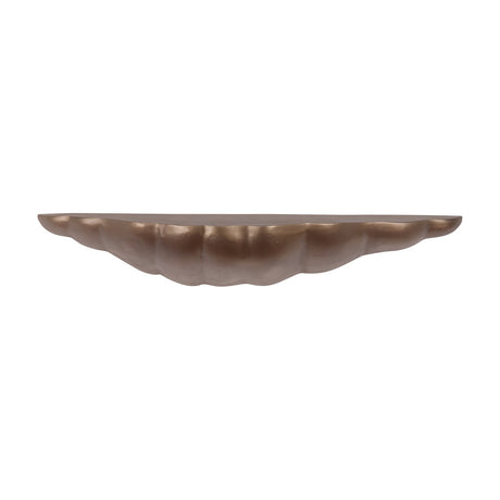 Libra Interiors cast aluminium sculpted wall shelf in antique brass, with an organic asymmetric shell-like form and lightly textured finish, on white.