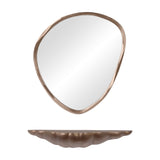Libra Interiors cast aluminium sculpted wall shelf in antique brass shown below a coordinating organic-shaped brass-framed mirror on a white background.