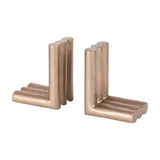 Libra Interiors Ribbed Cast Aluminium Bookends in antique brass, a pair of L-shaped supports formed from trios of fluted cylindrical columns.